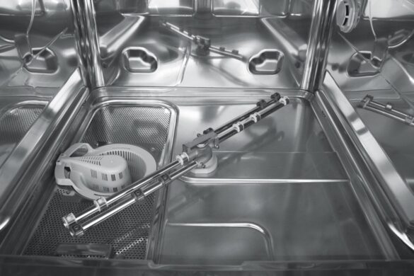 Interior of an empty stainless steel dishwasher showing the spray arm, filter, and metal racks.